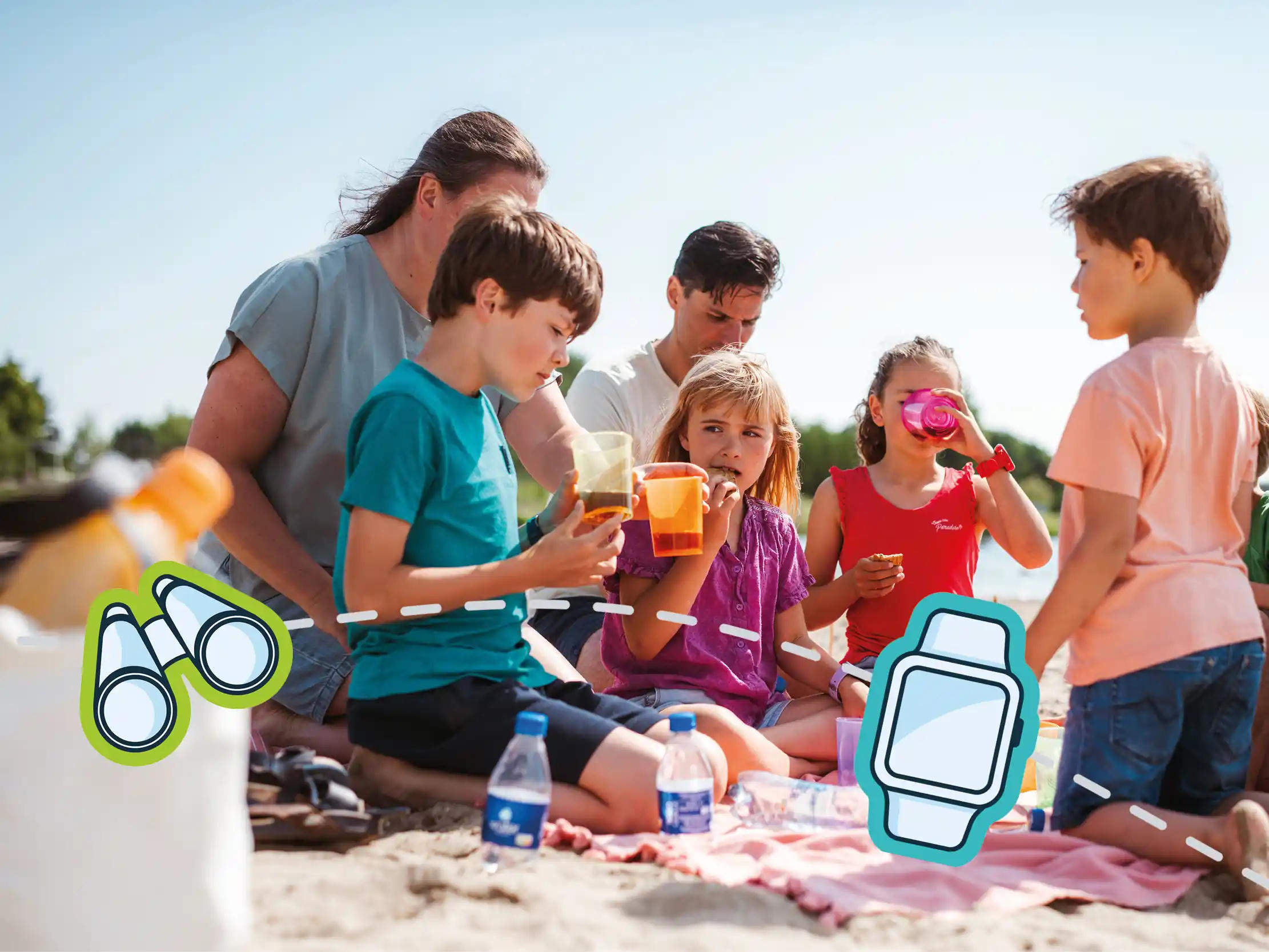 Familie mit Kindern beim entspannten Picknick am Strand während der Pfingstferien mit one2track Kinder-Smartwatch und gemeinsamen Familienmomenten im Freien